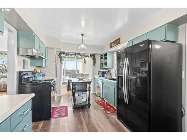 a kitchen with refrigerator and cabinets