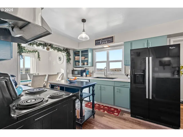 a kitchen with stainless steel appliances granite countertop a stove refrigerator and cabinets
