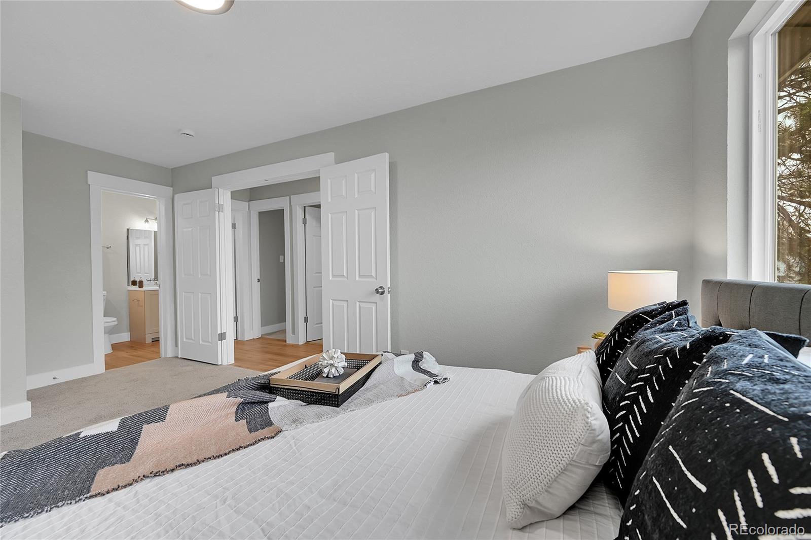 1344 Sable Boulevard Aurora, CO 80011 - Photo 18 of 31 a bedroom with a bed and a window