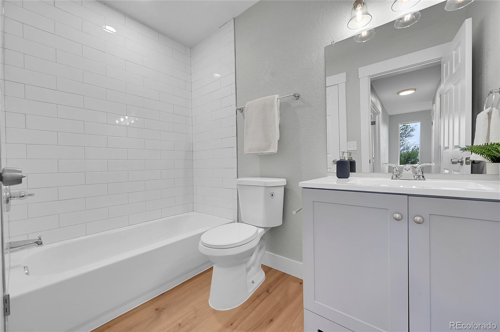 1344 Sable Boulevard Aurora, CO 80011 - Photo 24 of 31 a bathroom with a sink toilet and shower