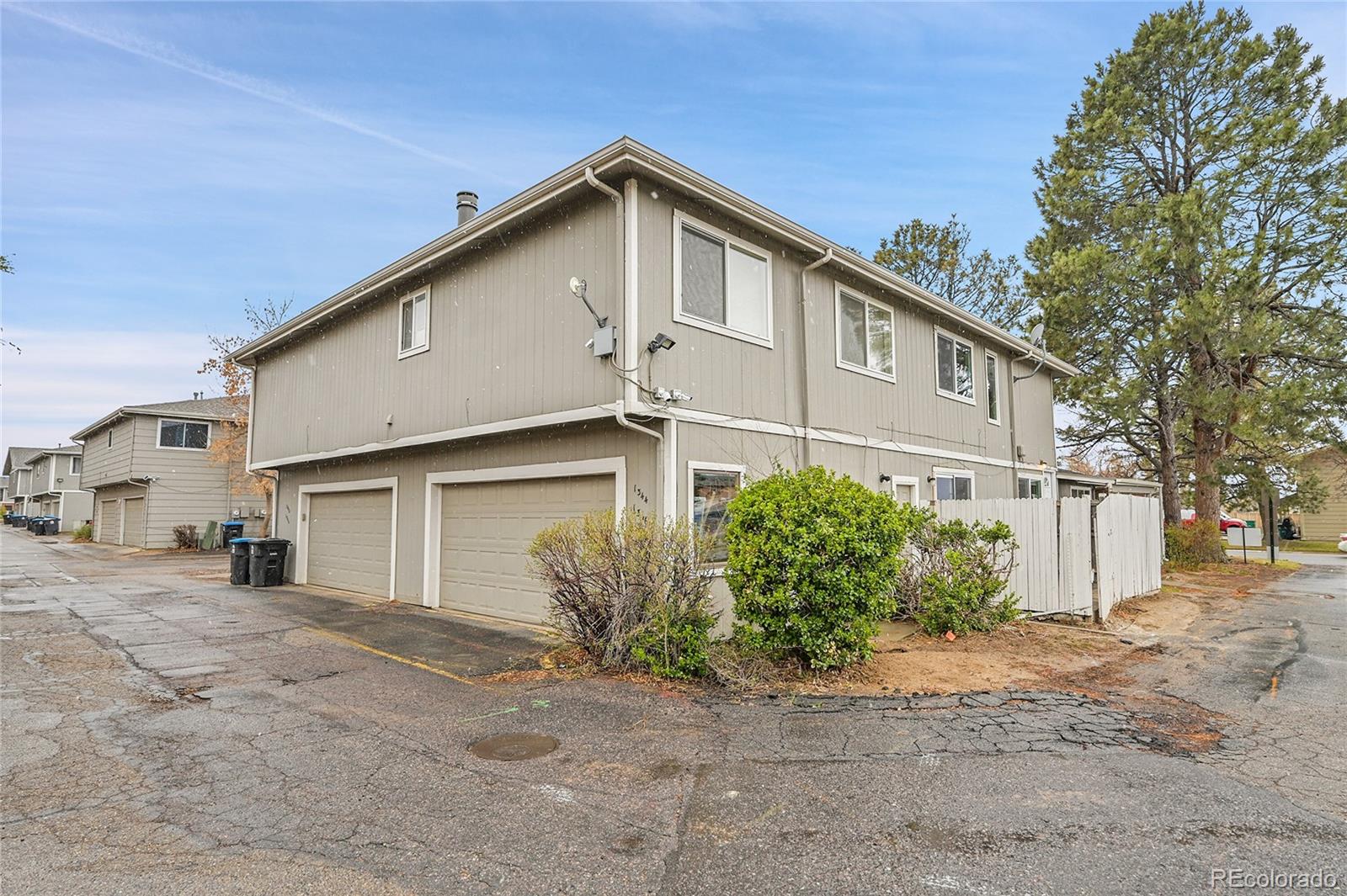 1344 Sable Boulevard Aurora, CO 80011 - Photo 26 of 31 a front view of a house with a yard and garage