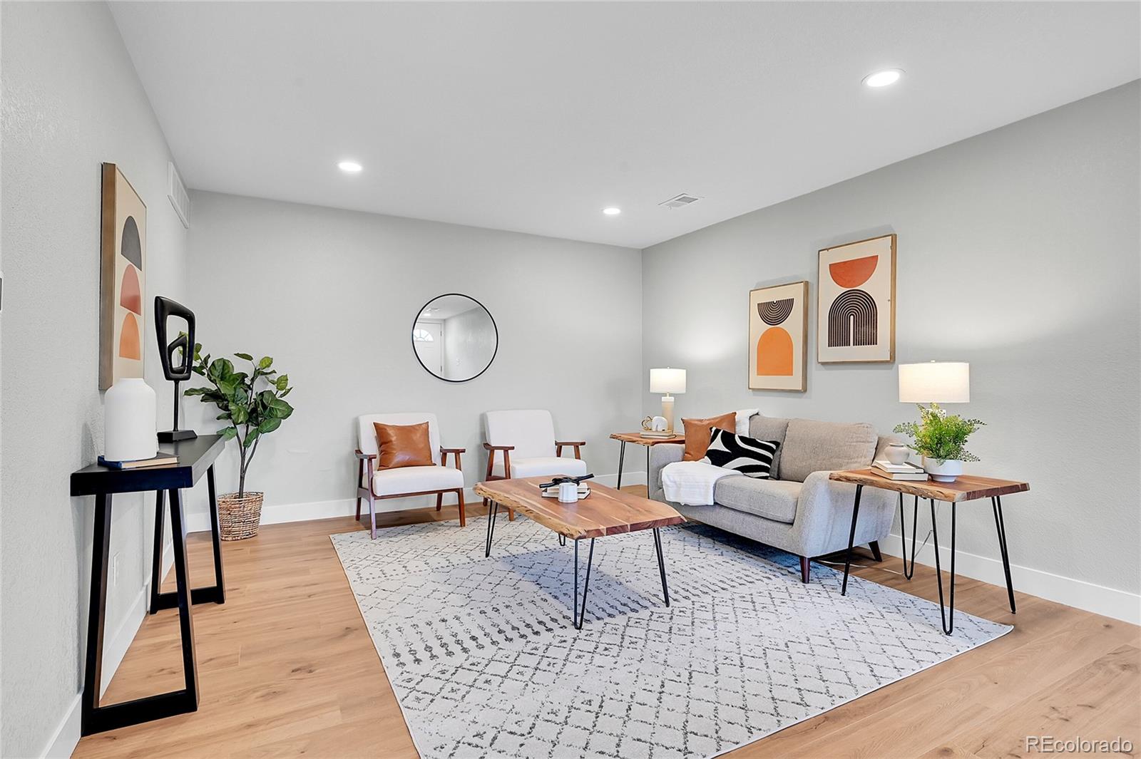 1344 Sable Boulevard Aurora, CO 80011 - Photo 5 of 31 a living room with furniture rug and a potted plant