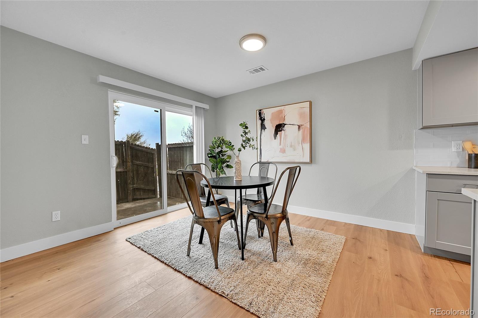 1344 Sable Boulevard Aurora, CO 80011 - Photo 9 of 31 a dining room with furniture and window