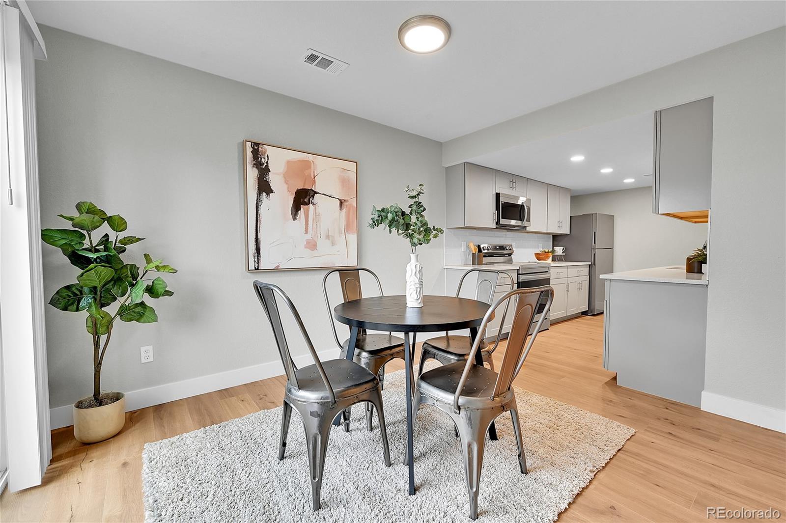 1344 Sable Boulevard Aurora, CO 80011 - Photo 10 of 31 a view of a dining room with furniture and a potted plant