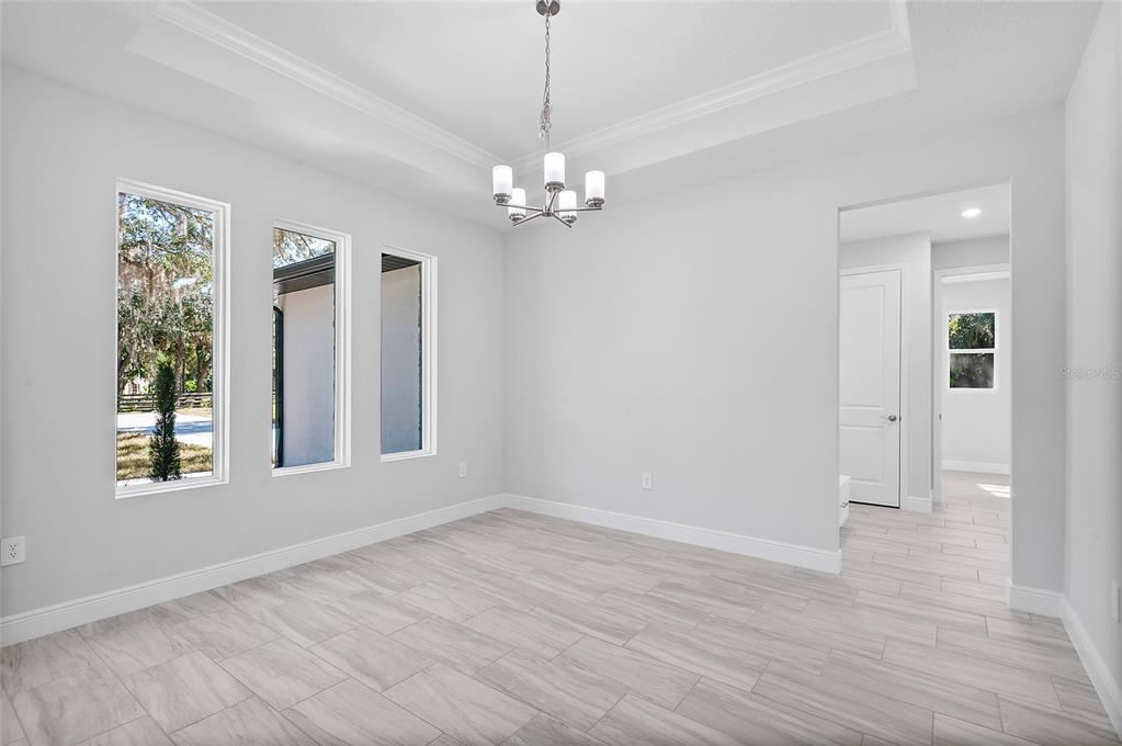 304 North Jungle Road Geneva, FL 32732 - Photo 21 of 49 a view of an empty room with a window and wooden floor
