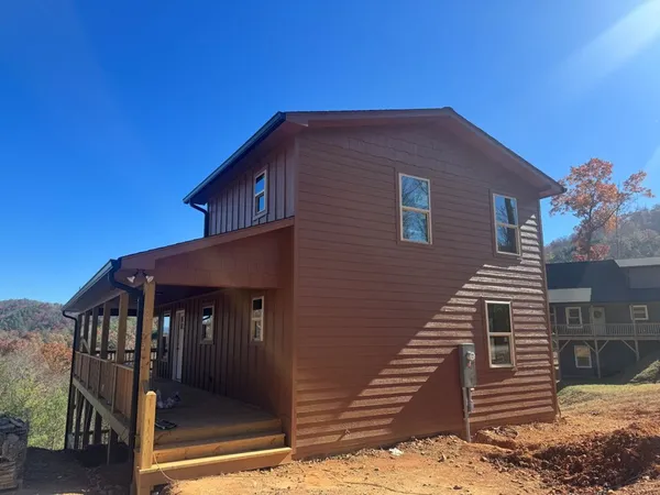 a front view of a house with wooden stairs
