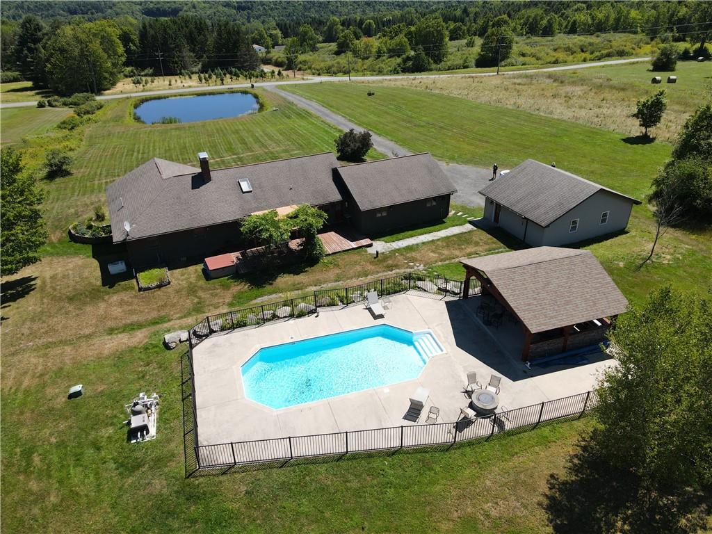 an aerial view of a house having outdoor space swimming pool and tennis court