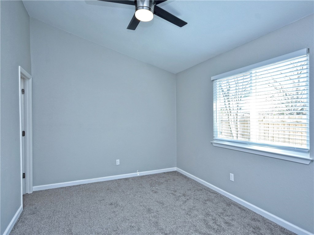 2302 Fuzz Fairway, Unit B Austin, TX 78728 - Photo 14 of 27 Master Bedroom with high ceiling, contemporary ceiling fan, new carpet, paint and 2 inch blind.