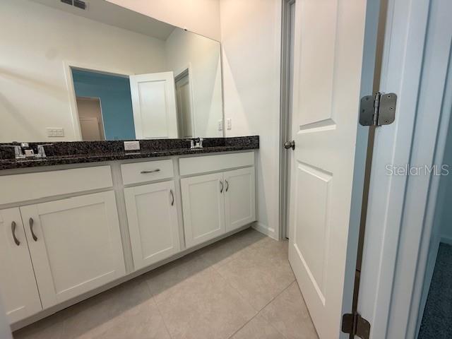 1913 Seawall Way Celebration, FL 34747 - Photo 12 of 34 a bathroom with a double vanity sink and a mirror