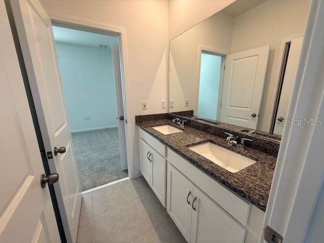 1913 Seawall Way Celebration, FL 34747 - Photo 16 of 34 a bathroom with a granite countertop sink and a mirror