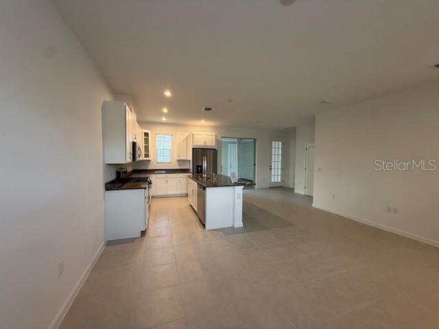 1913 Seawall Way Celebration, FL 34747 - Photo 3 of 34 a living room with stainless steel appliances kitchen island furniture and a kitchen view