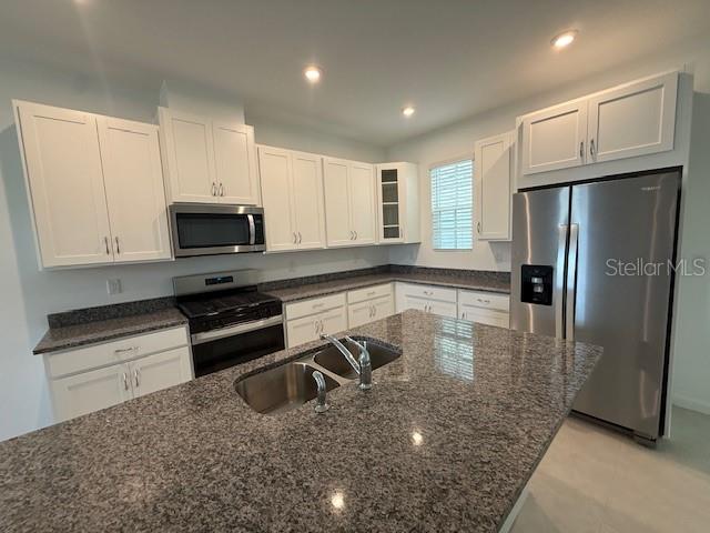 1913 Seawall Way Celebration, FL 34747 - Photo 4 of 34 a kitchen with stainless steel appliances granite countertop a refrigerator sink and stove
