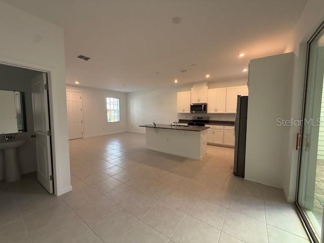 1913 Seawall Way Celebration, FL 34747 - Photo 7 of 34 a view of a kitchen with a refrigerator and a sink