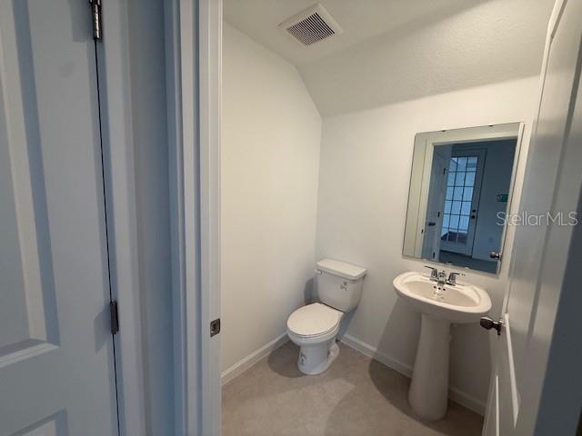 1913 Seawall Way Celebration, FL 34747 - Photo 9 of 34 a bathroom with a toilet sink and mirror