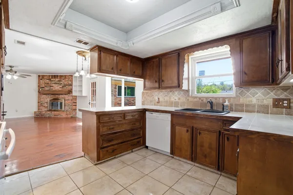 a kitchen with stainless steel appliances granite countertop a sink and cabinets