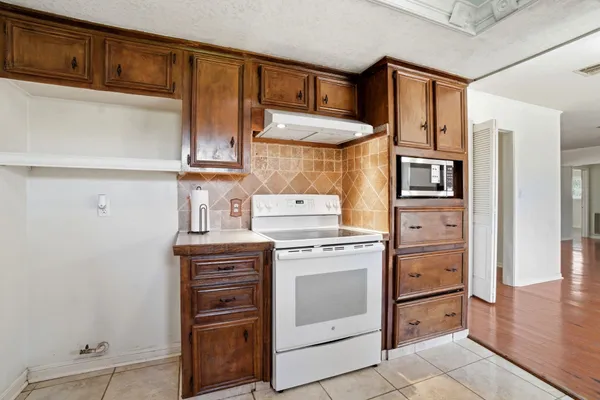 a kitchen with stainless steel appliances granite countertop a refrigerator and a stove