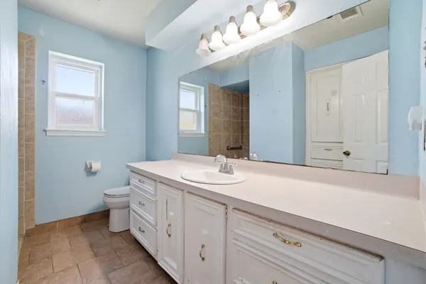 a bathroom with a sink a toilet and mirror