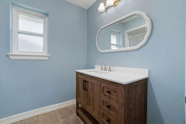 a bathroom with a sink a vanity and a mirror