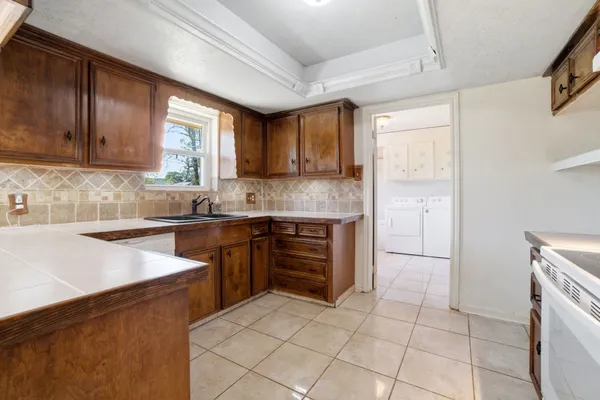 a kitchen with a stove a sink and a refrigerator