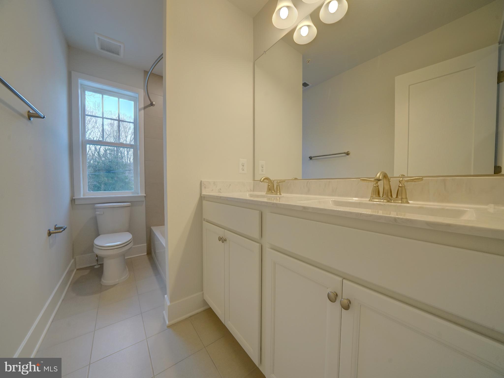 9425 Fairview Avenue Laurel, MD 20723 - Photo 115 of 125 a bathroom with a toilet sink and mirror