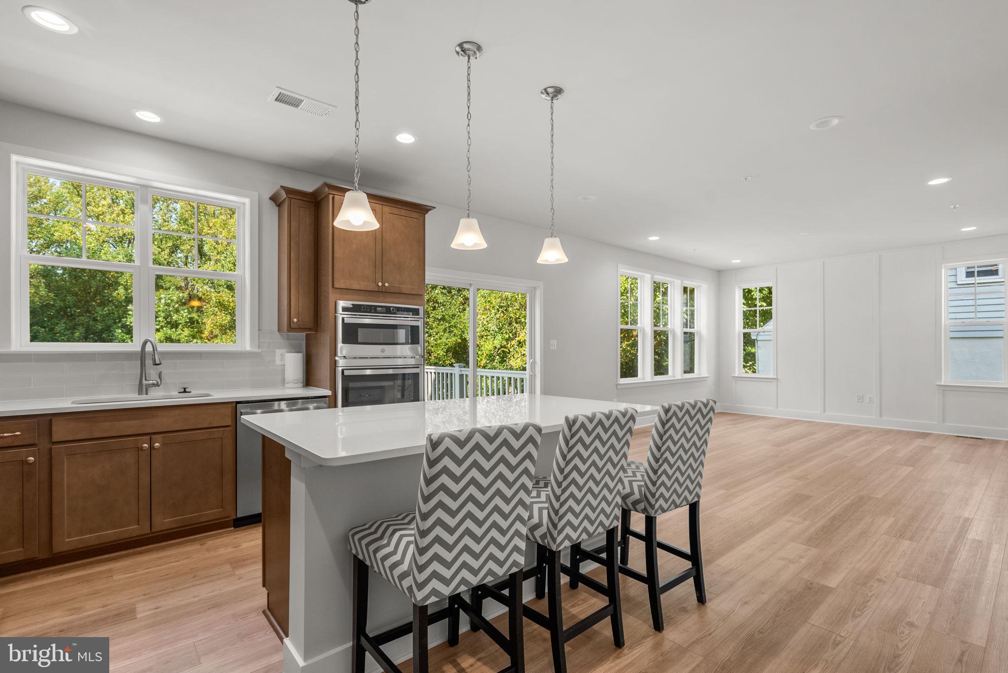 9425 Fairview Avenue Laurel, MD 20723 - Photo 12 of 125 a kitchen with a table chairs sink and cabinets