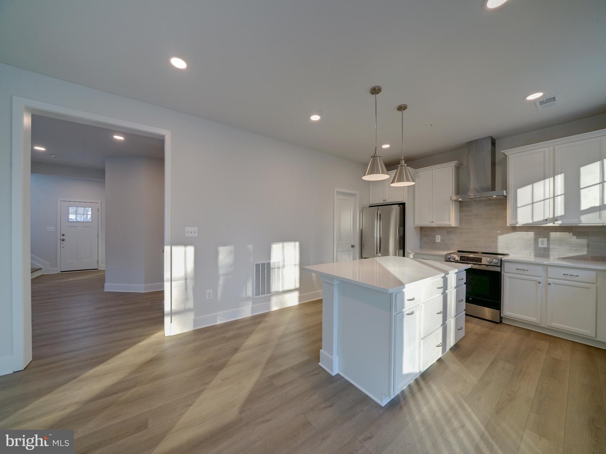 9425 Fairview Avenue Laurel, MD 20723 - Photo 68 of 125 a kitchen with stainless steel appliances granite countertop a sink a stove and a wooden floors
