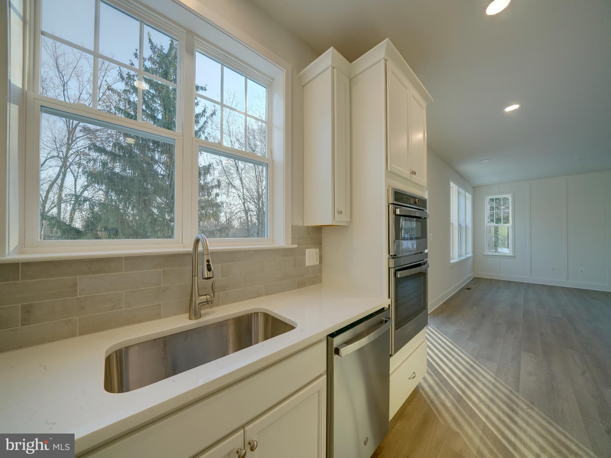 9425 Fairview Avenue Laurel, MD 20723 - Photo 71 of 125 a kitchen with stainless steel appliances wooden cabinets a sink and a large window