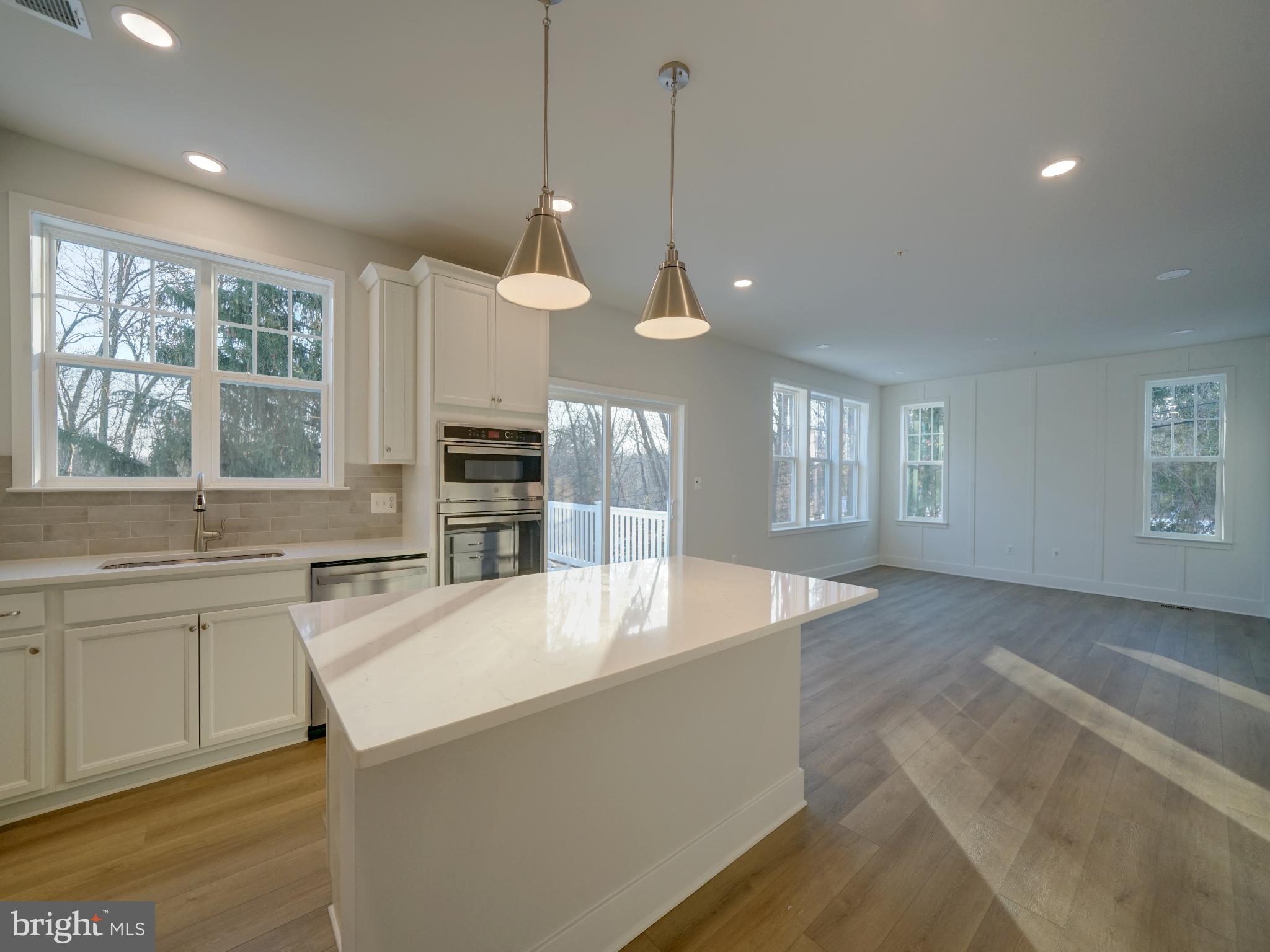 9425 Fairview Avenue Laurel, MD 20723 - Photo 76 of 125 a large kitchen with kitchen island a large counter space a sink and appliances