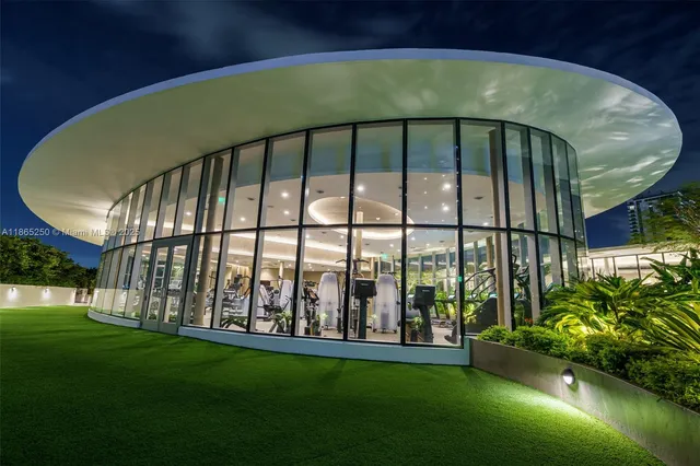a view of a house with a yard and potted plants