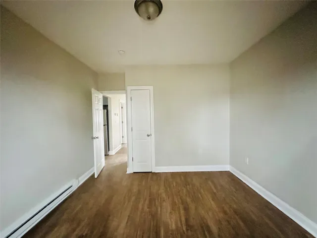 a view of an empty room and wooden floor