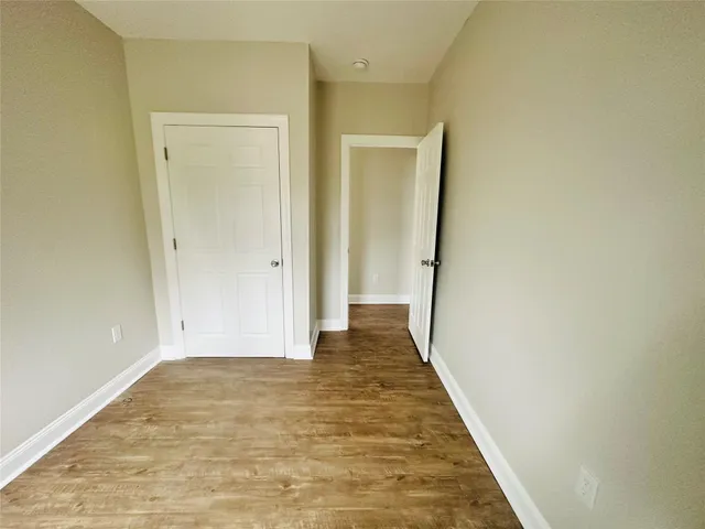a view of hallway with wooden floor