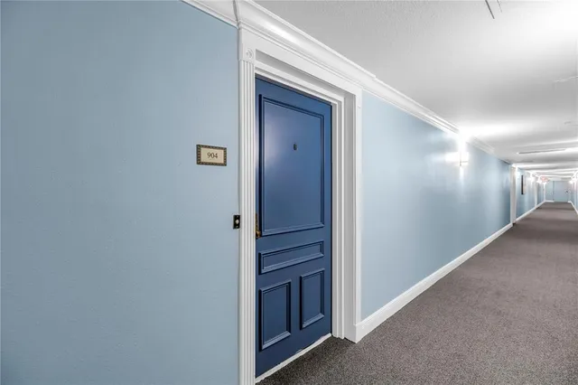 a view of a kitchen with sink and a refrigerator
