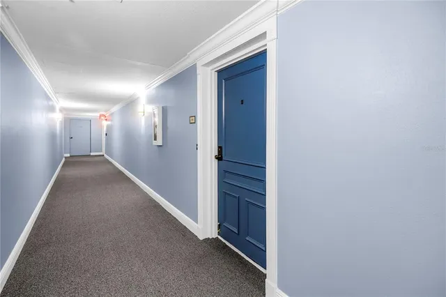 a view of a dining room with furniture and a chandelier