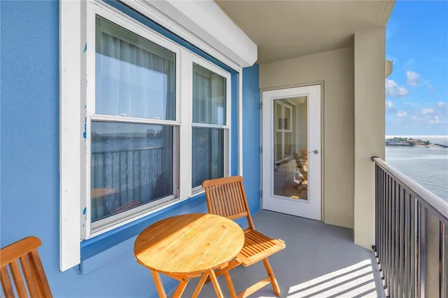 a terrace with a table and chairs and potted plants