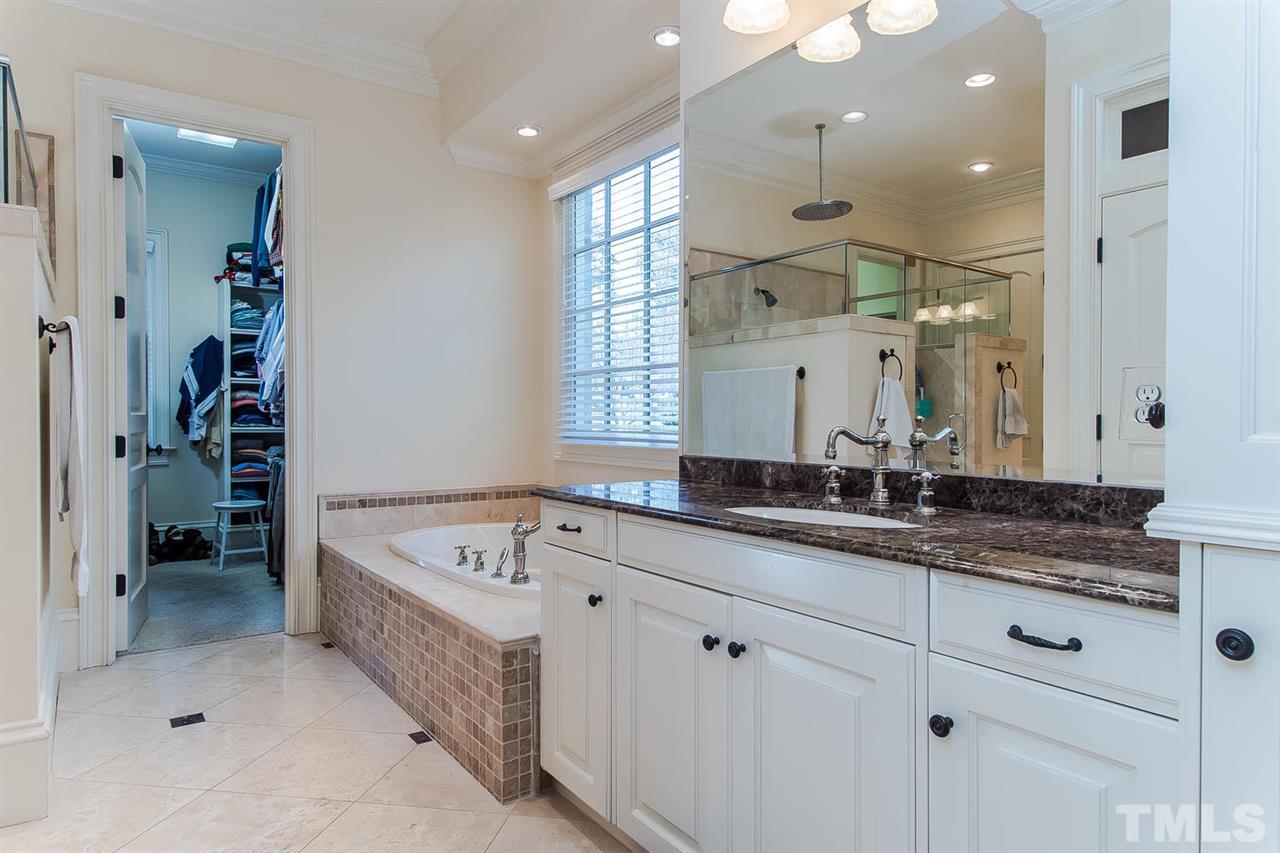 508 Marlowe Road Raleigh, NC 27609 - Photo 22 of 25 a spacious bathroom with a granite countertop sink mirror and bathtub