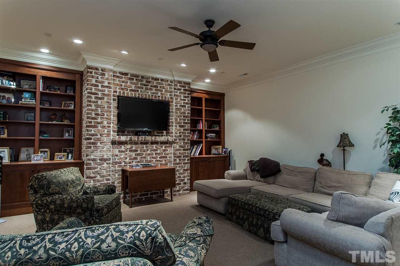 508 Marlowe Road Raleigh, NC 27609 - Photo 23 of 25 a living room with furniture a flat screen tv and a fireplace