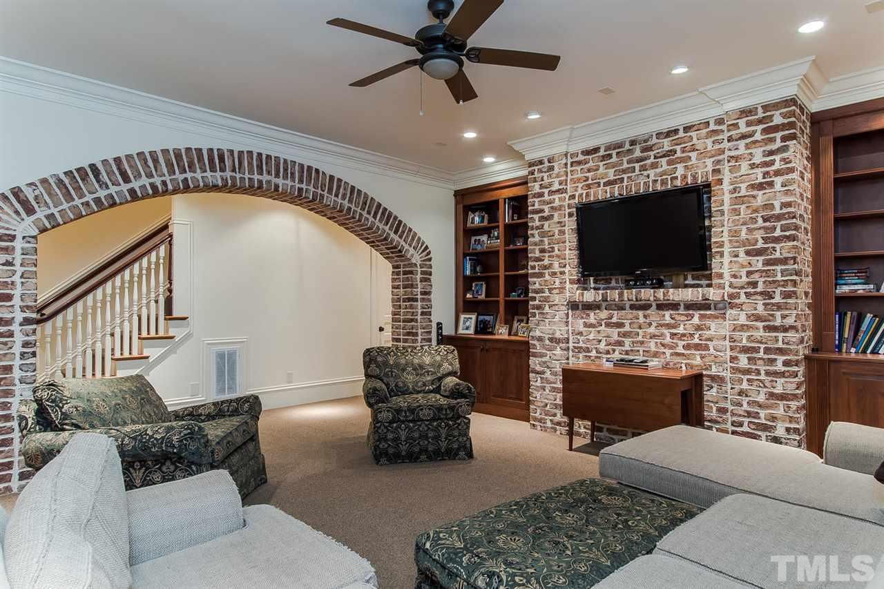 508 Marlowe Road Raleigh, NC 27609 - Photo 24 of 25 a living room with fireplace furniture and a flat screen tv