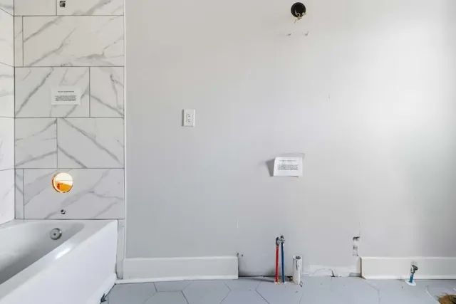 a bathroom with a bathtub and shower