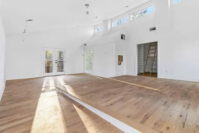 a view of a room with wooden floor