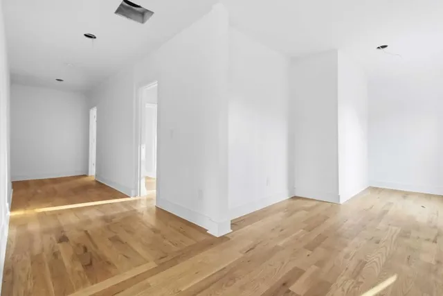 a view of a hallway with wooden shelves