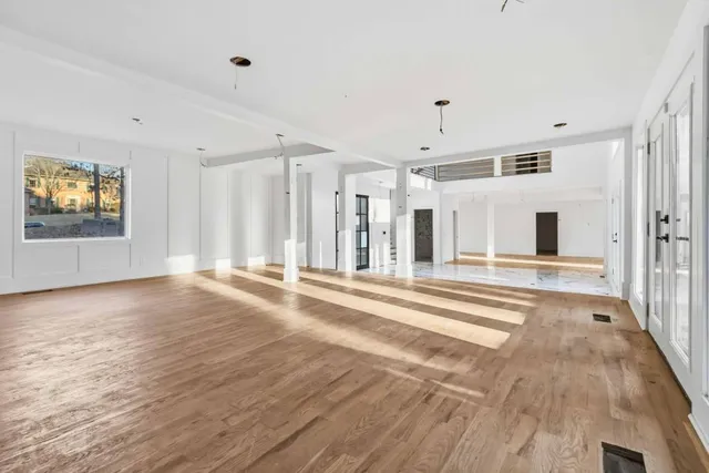 a view of a livingroom with wooden floor and windows