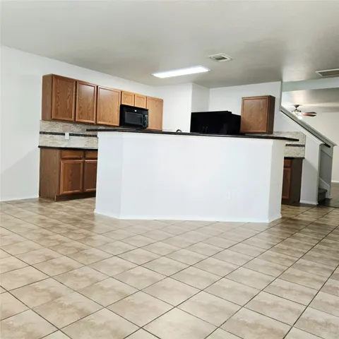 a view of a kitchen with stainless steel appliances cabinets