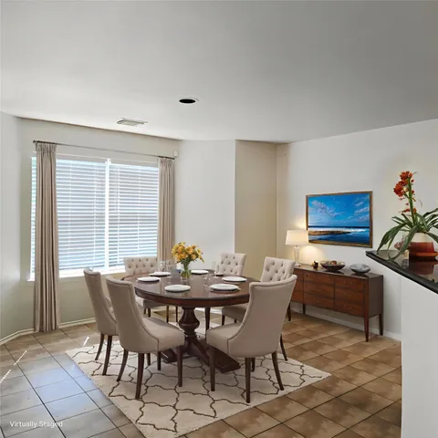 a dining room with furniture and window