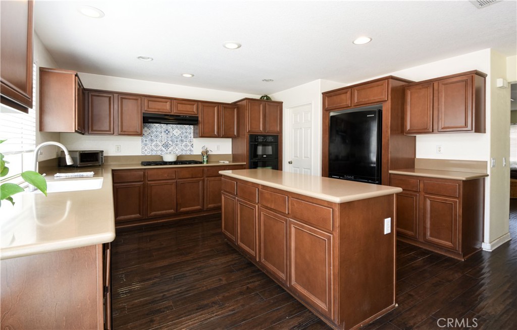 35630 Bryce Road Winchester, CA 92596 - Photo 10 of 32 a kitchen with stainless steel appliances granite countertop a sink stove and refrigerator
