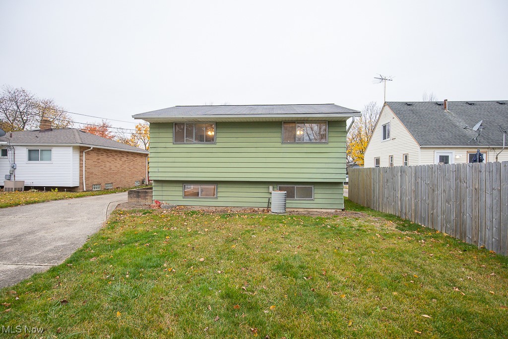 4357 Valleyside Road Cleveland, OH 44135 - Photo 26 of 26 Back of house featuring a lawn and central AC unit