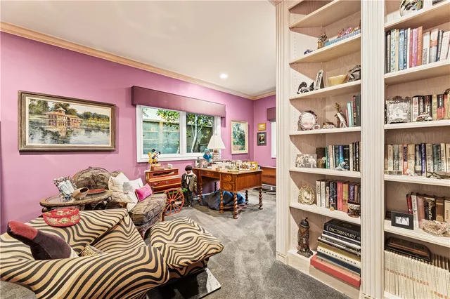 a living room with furniture book shelf and a book shelf