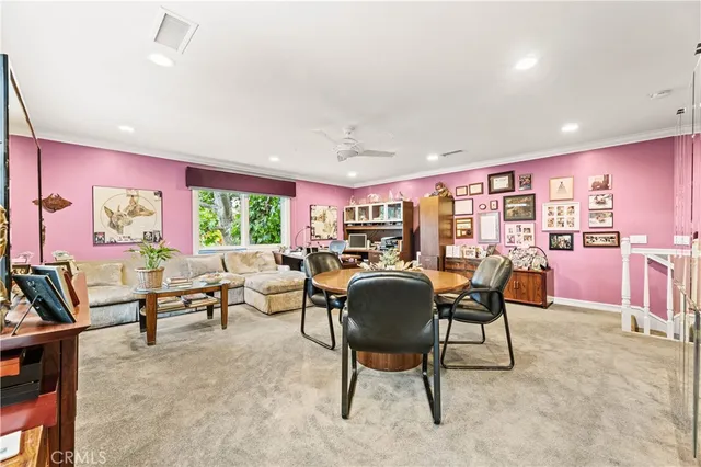 a living room with furniture a rug and a large window