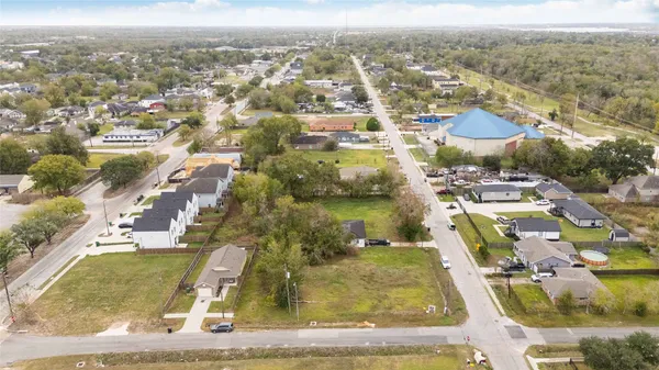 an aerial view of residential houses with city view