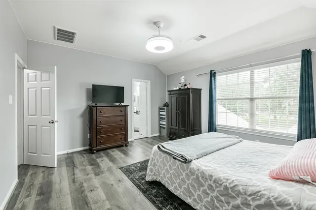 a bedroom with a bed and a television