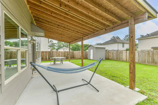 a backyard of a house with garden and plants